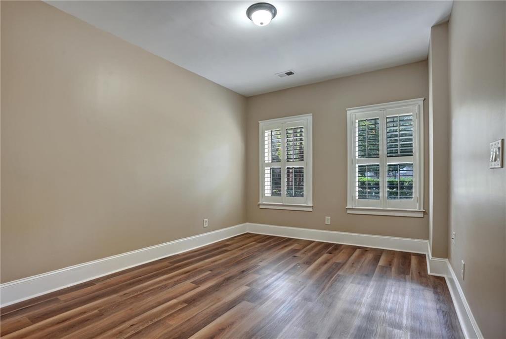 2443 Gatebury Circle Atlanta, GA 30341 - Photo 22 of 45 an empty room with wooden floor and windows