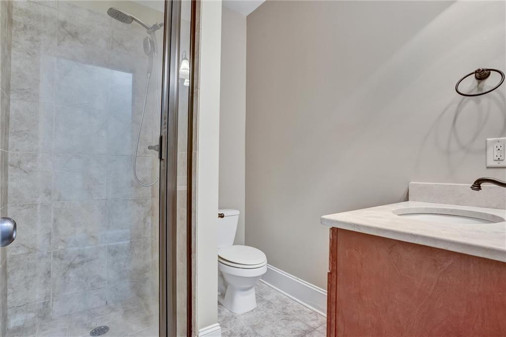 2443 Gatebury Circle Atlanta, GA 30341 - Photo 24 of 45 a bathroom with a sink a toilet and shower