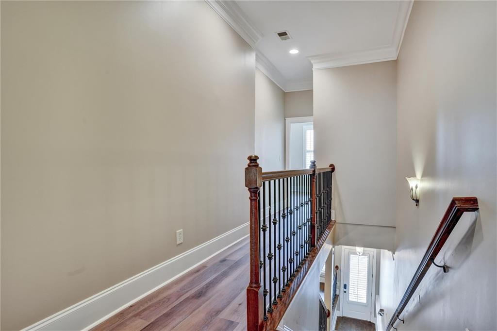 2443 Gatebury Circle Atlanta, GA 30341 - Photo 28 of 45 a view of a hallway with wooden floor and stairs