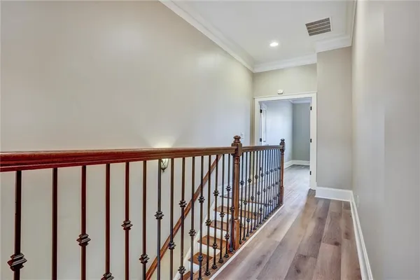 a view of a hallway with wooden floor