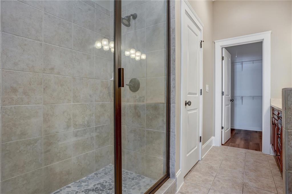 2443 Gatebury Circle Atlanta, GA 30341 - Photo 39 of 45 a bathroom with a glass shower door