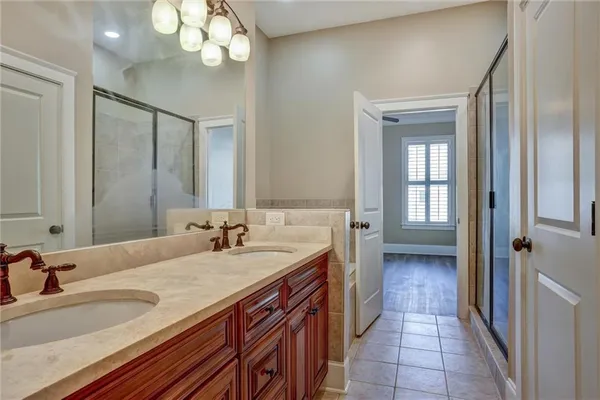a spacious bathroom with a granite countertop sink a mirror and a vanity