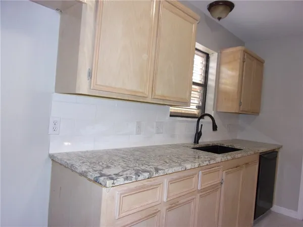 a kitchen with granite countertop a sink