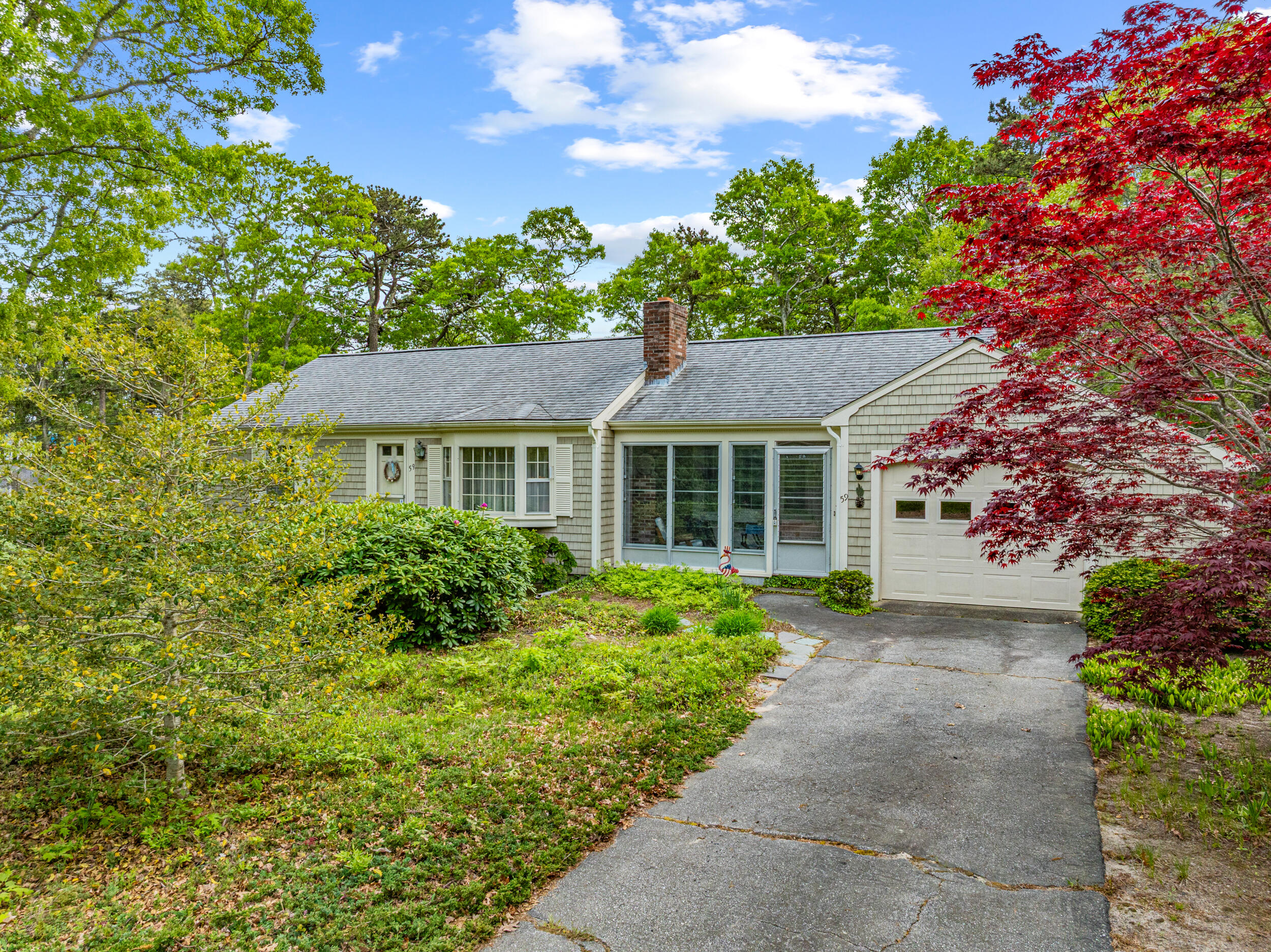 59 Beverly Road West Yarmouth, MA 02673 - Photo 4 of 33 a front view of a house with a garden