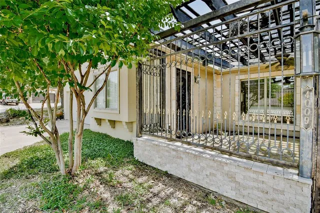 a view of a house with a tree in front