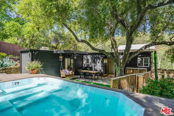 a view of a house with backyard outdoor seating and a patio