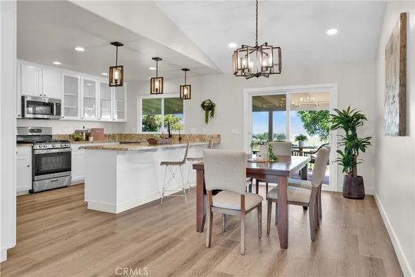 a kitchen with a sink cabinets and wooden floor