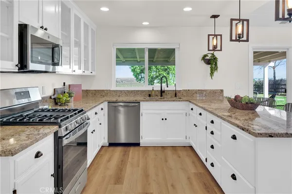 a kitchen with stainless steel appliances granite countertop a stove and a refrigerator