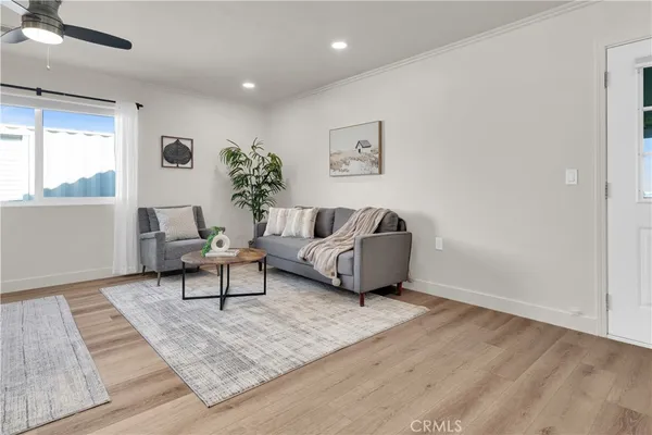 a living room with furniture and a potted plant