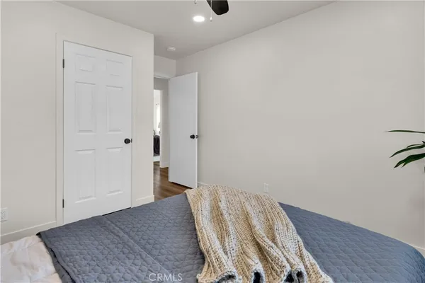 a bed room with a bed and a potted plant