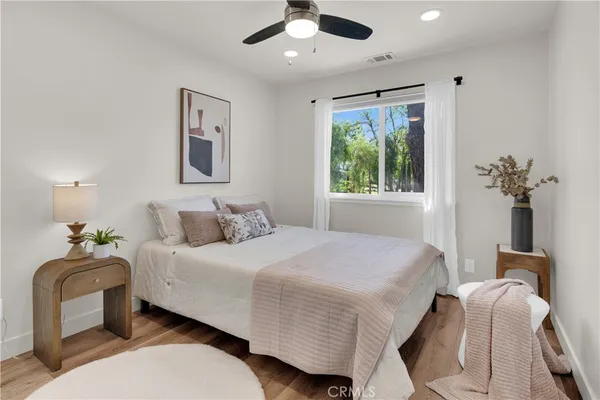 a bedroom with a bed and a mirror