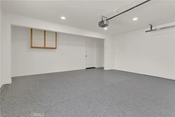 a view of a patio with chairs and table with chairs and floor to ceiling window