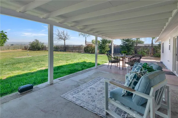 a view of a house with backyard porch and sitting area