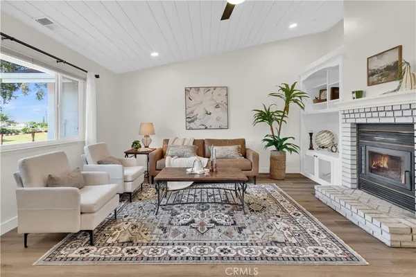 a living room with furniture and a fireplace