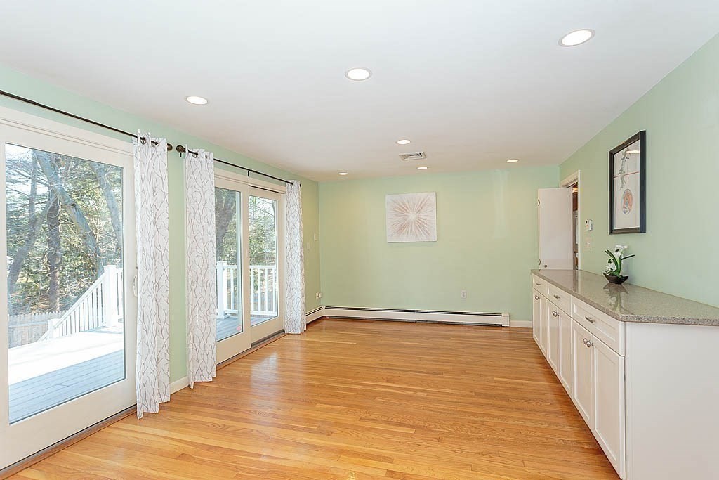 130 Worthen Road Lexington, MA 02421 - Photo 11 of 27 a view of an empty room with wooden floor and a window