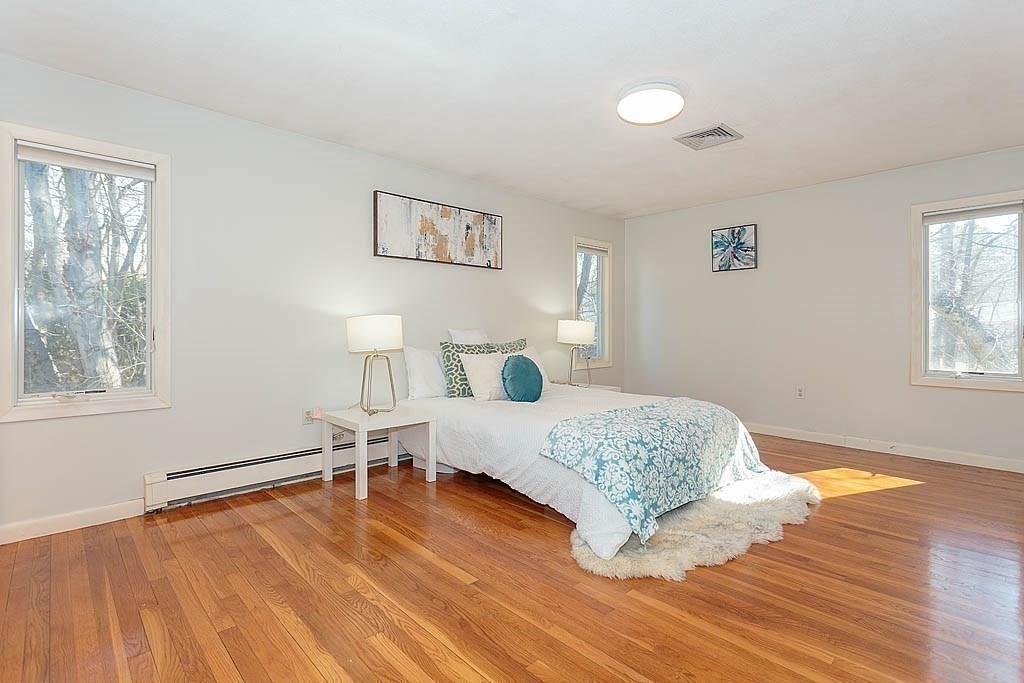 130 Worthen Road Lexington, MA 02421 - Photo 12 of 27 a bedroom with a bed and wooden floor