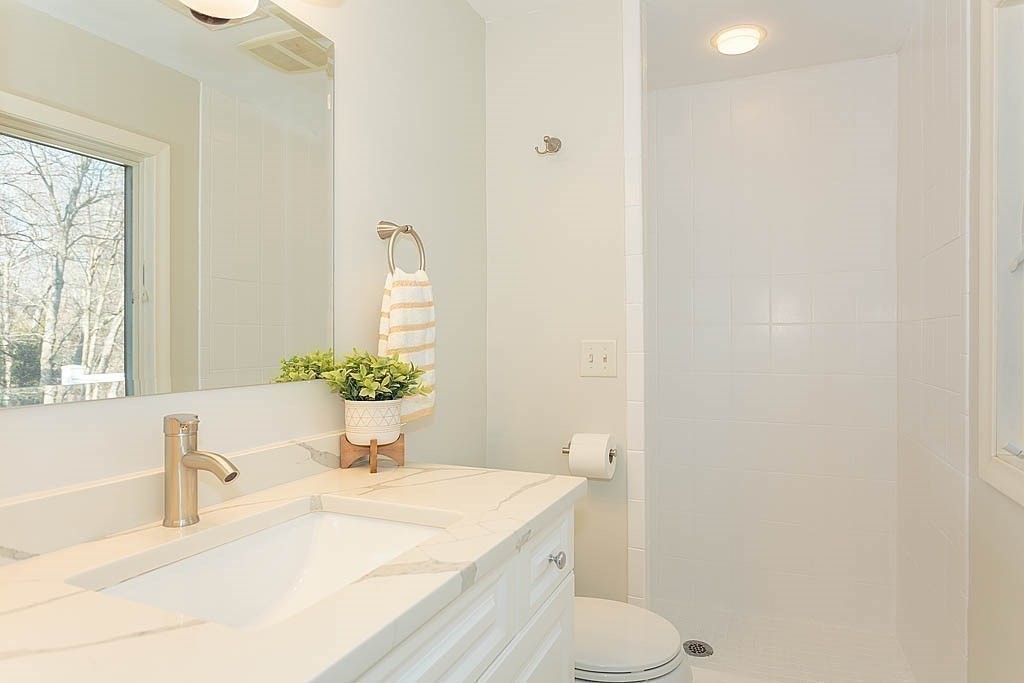 130 Worthen Road Lexington, MA 02421 - Photo 13 of 27 a bathroom with a sink toilet and window