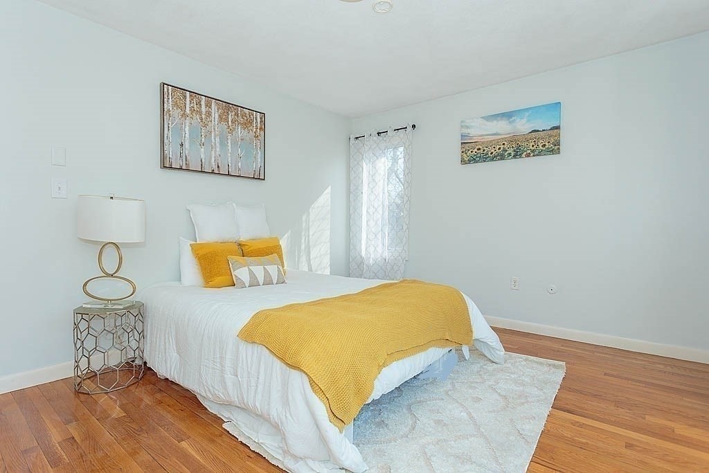 130 Worthen Road Lexington, MA 02421 - Photo 15 of 27 a bedroom with a bed and wooden floor