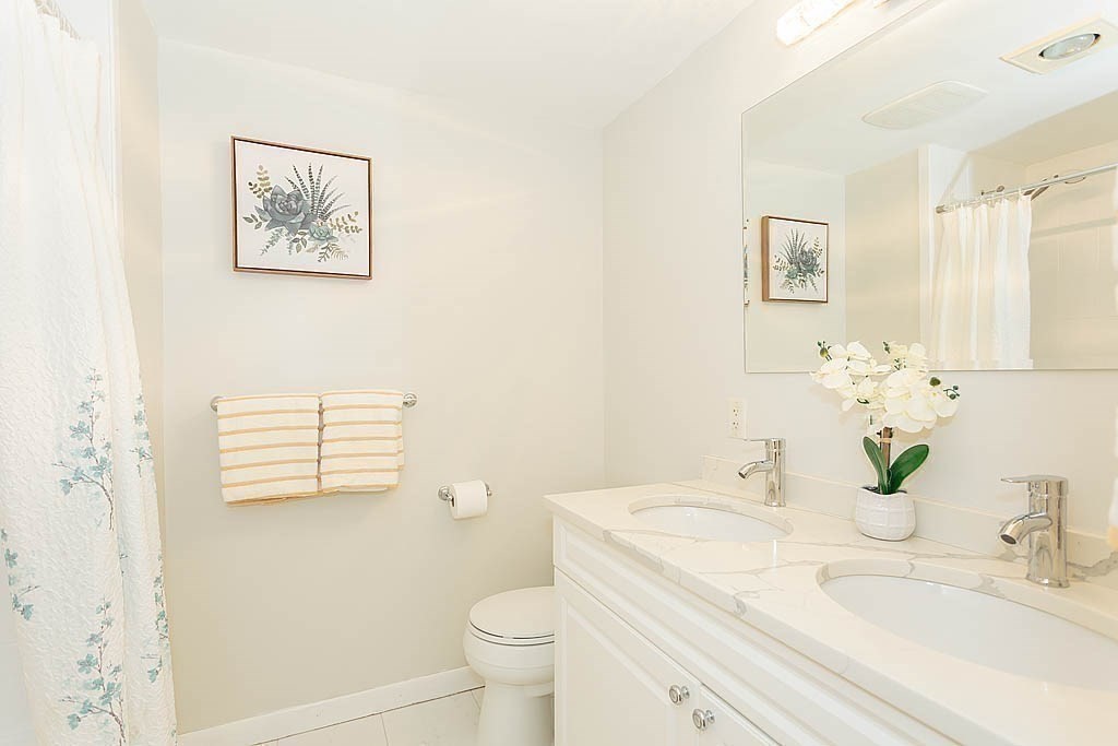 130 Worthen Road Lexington, MA 02421 - Photo 16 of 27 a bathroom with a granite countertop sink mirror vanity and toilet