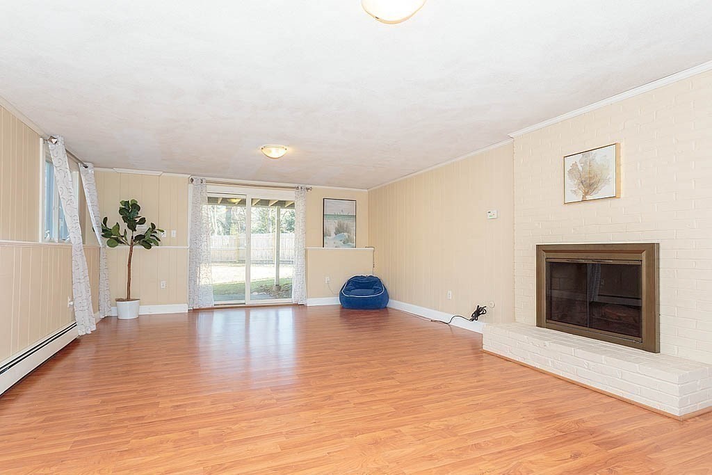 130 Worthen Road Lexington, MA 02421 - Photo 18 of 27 a view of empty room with wooden floor and fireplace