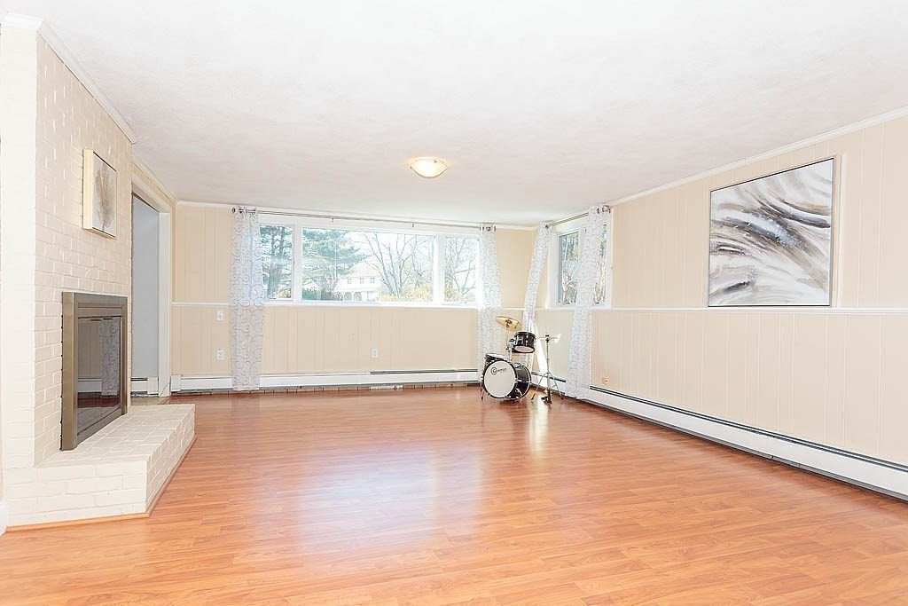 130 Worthen Road Lexington, MA 02421 - Photo 19 of 27 a view of an empty room with wooden floor and a window