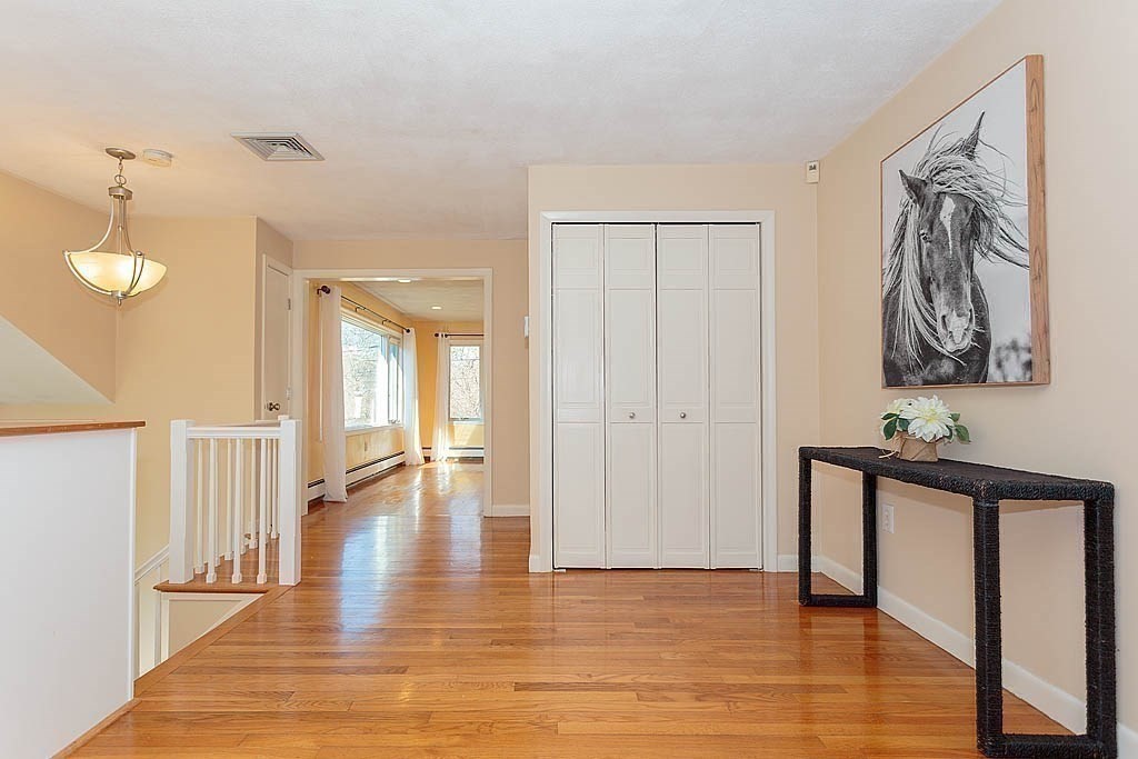 130 Worthen Road Lexington, MA 02421 - Photo 2 of 27 a view of a hallway with wooden floor and staircase