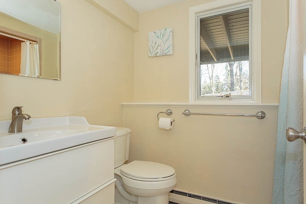 130 Worthen Road Lexington, MA 02421 - Photo 23 of 27 a bathroom with a sink a toilet and a window