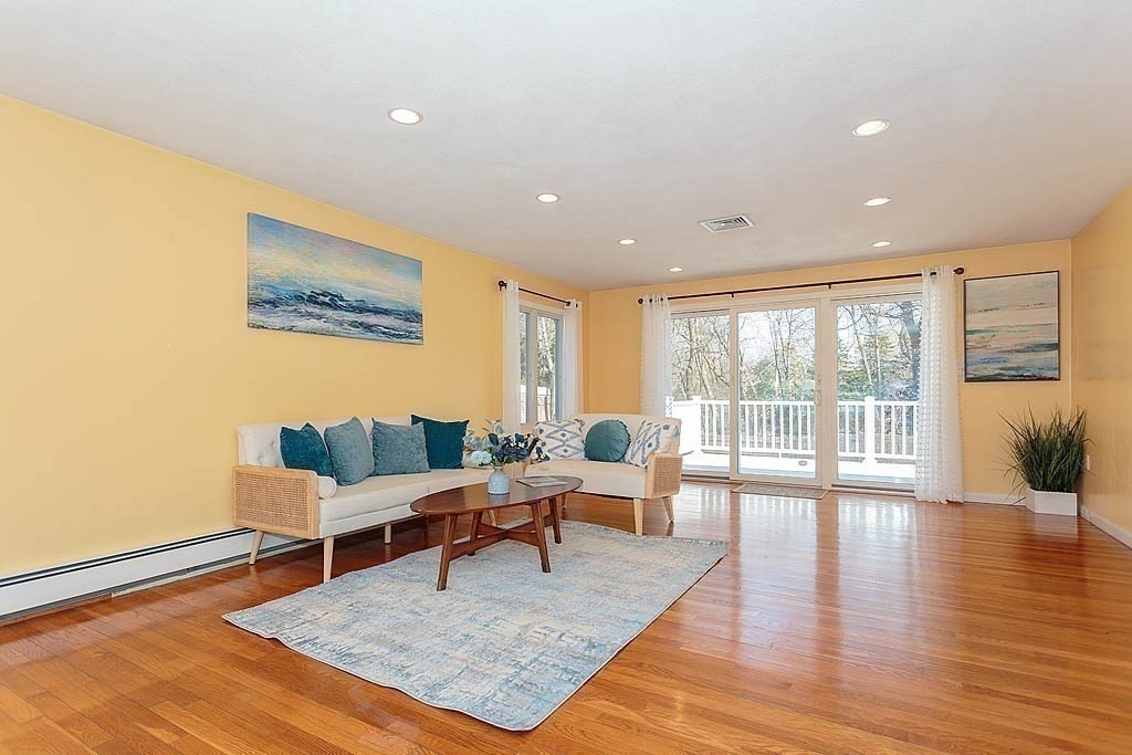 130 Worthen Road Lexington, MA 02421 - Photo 5 of 27 a living room with furniture large wooden floor and a large window
