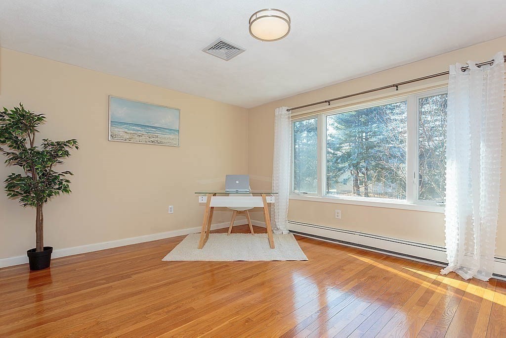130 Worthen Road Lexington, MA 02421 - Photo 6 of 27 wooden floor in an empty room with a window