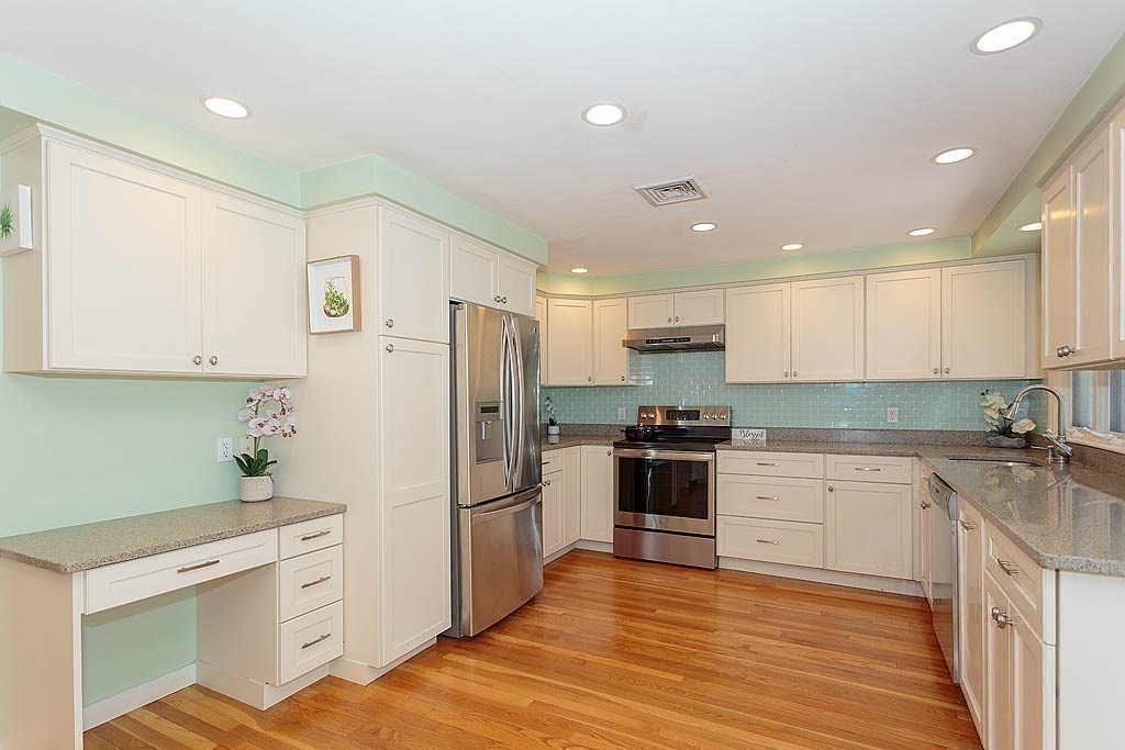 130 Worthen Road Lexington, MA 02421 - Photo 8 of 27 a kitchen with white cabinets stainless steel appliances and a counter space
