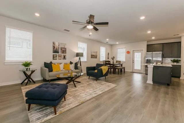 a living room with furniture and kitchen view