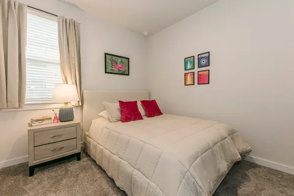 a bedroom with bed and a window