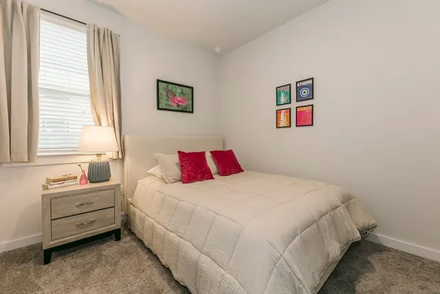 a bedroom with bed and a window