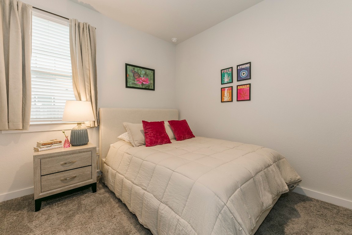 265 Garner Drive Kyle, TX 78640 - Photo 11 of 14 a bedroom with bed and a window