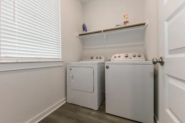 a view of washer and dryer with wooden floor