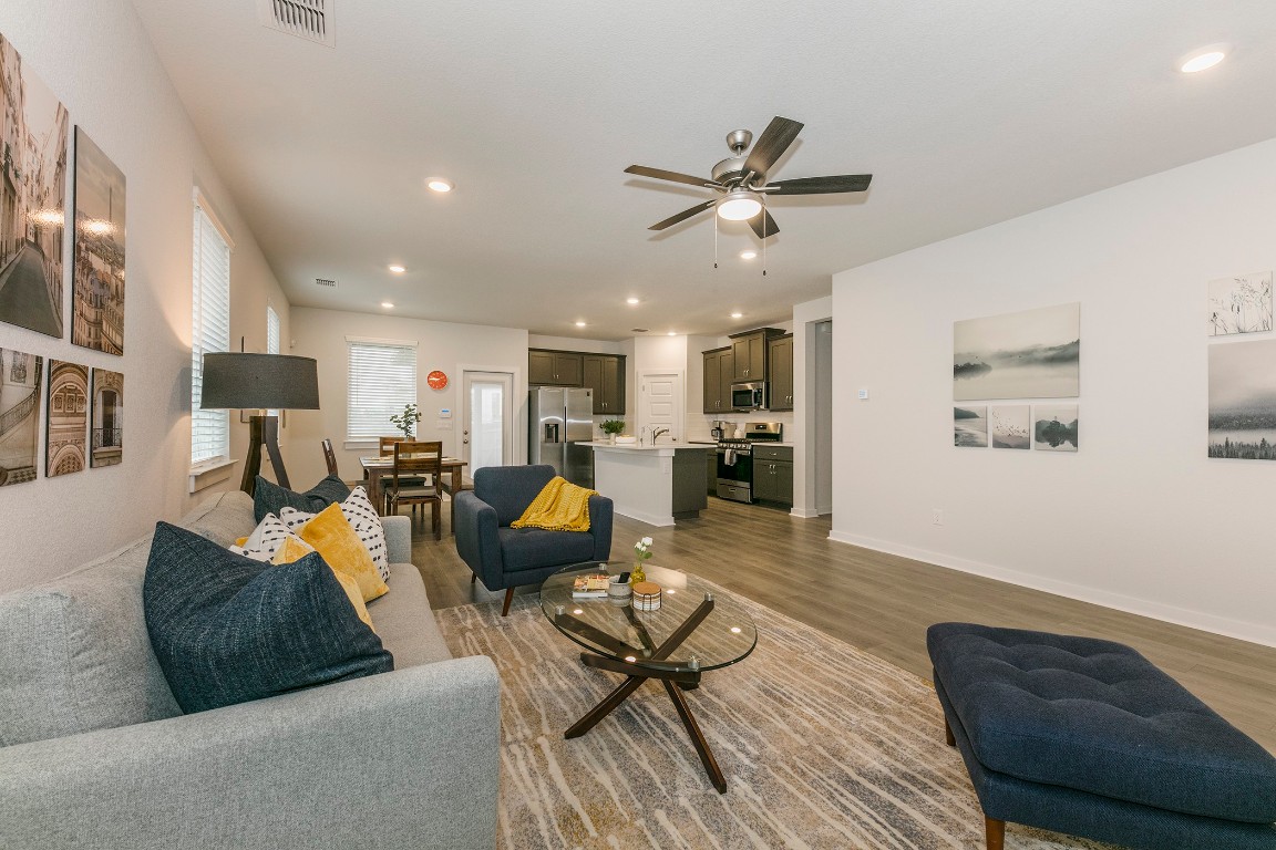 265 Garner Drive Kyle, TX 78640 - Photo 2 of 14 a living room with furniture kitchen view and a wooden floor
