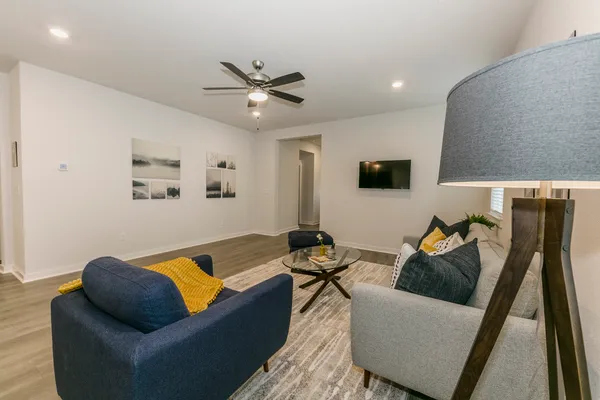 a living room with furniture and a flat screen tv