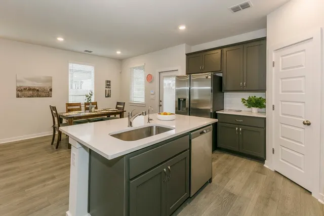 a kitchen with a sink stove and refrigerator