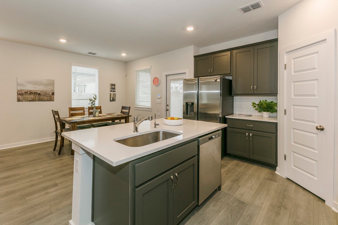 265 Garner Drive Kyle, TX 78640 - Photo 6 of 14 a kitchen with a sink stove and refrigerator