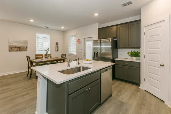 a kitchen with a sink stove and refrigerator