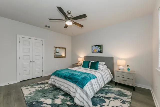 a bedroom with a bed and a chandelier
