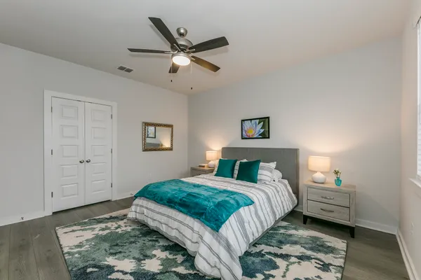 a bedroom with a bed and a chandelier