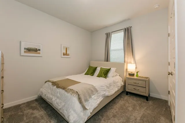 a bedroom with a bed and window