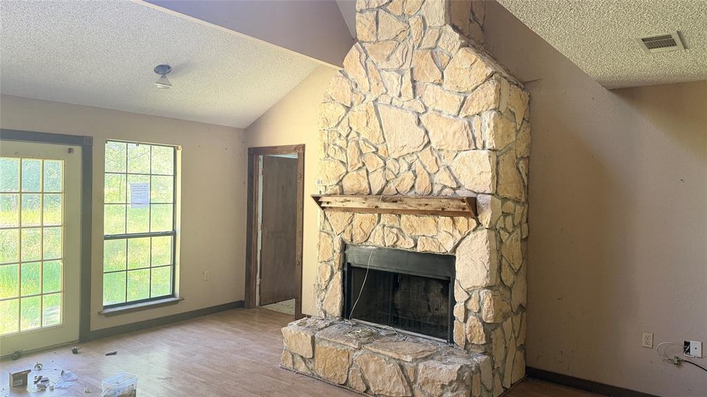 6582 Taylor Road Kaufman, TX 75142 - Photo 13 of 40 an empty room with windows and a fireplace