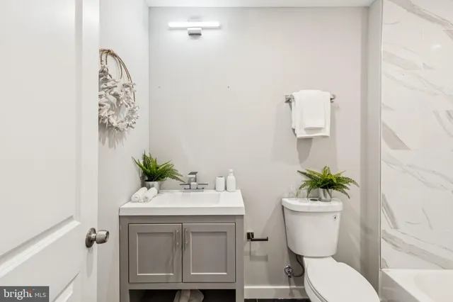 a bathroom with a sink toilet and a mirror