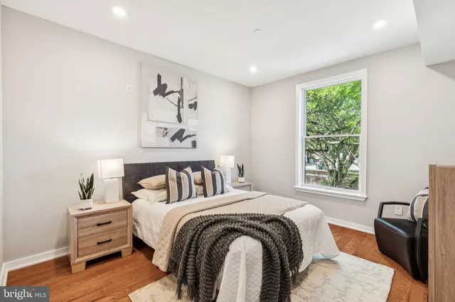 a bedroom with a bed and wooden floor