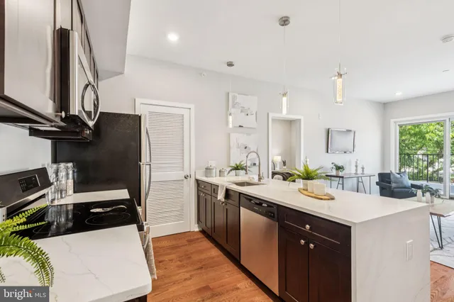 a kitchen with a sink appliances and cabinets