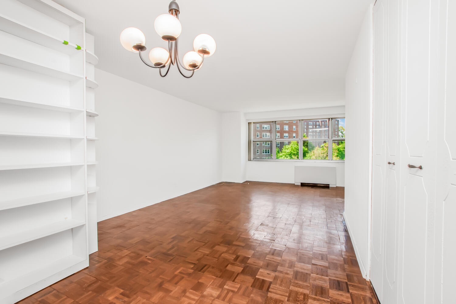 555 Kappock Street, Unit 7M Bronx, NY 10463 - Photo 5 of 17 a view of a hallway with a window and a chandelier