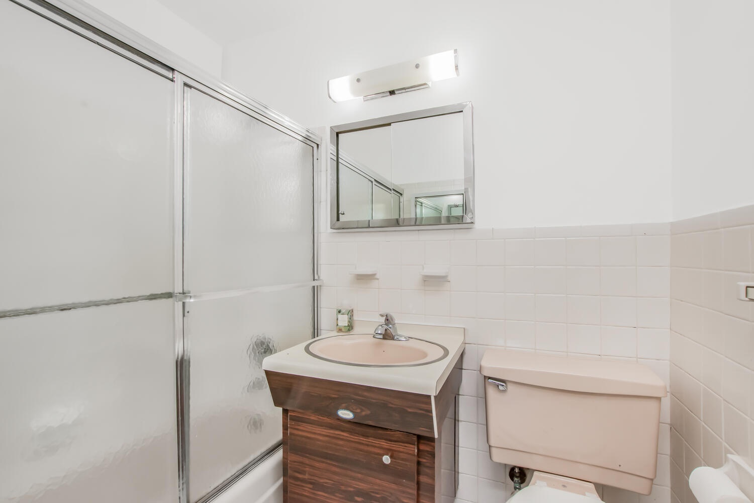 555 Kappock Street, Unit 7M Bronx, NY 10463 - Photo 10 of 17 a bathroom with a sink a mirror and a shower