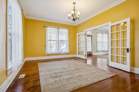 a view of an entryway with wooden floor and door